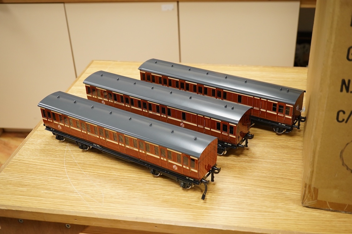 A boxed 0 gauge Darstaed tinplate Metropolitan Railway set of bogie coaches, a rake of five coaches in teak livery including; two Brake Thirds, two Full Thirds, and a Full First, fitted with internal lighting throughout